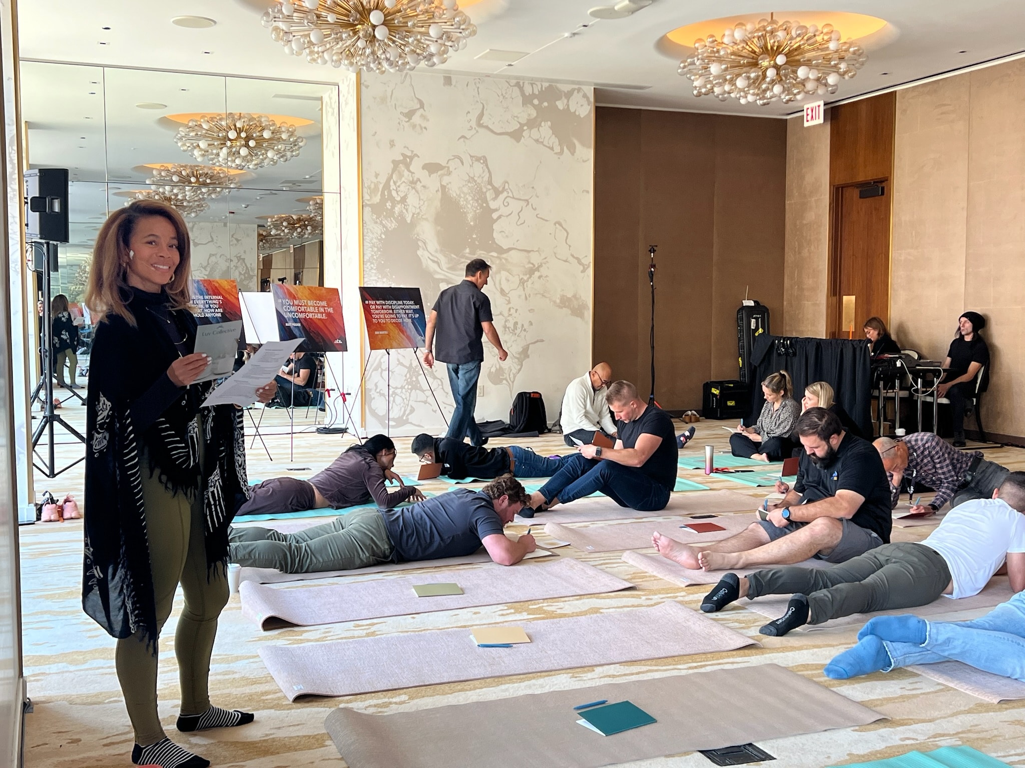 Courtney leading a corporate wellness session in a hotel ballroom